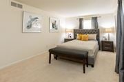 Baltimore apartment for rent - A bedroom with a large bed and two framed pictures on the wall at Spring Hill Apartments & Townhomes, Baltimore