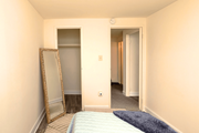 Baltimore apartment for rent - A bedroom with a bed, mirror and wardrobe at Kingston Townhomes, Baltimore, MD