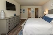 Randallstown apartment for rent - A bedroom with a large bed and a tv mounted on the wall at Deer Park Apartments, Randallstown, 21133
