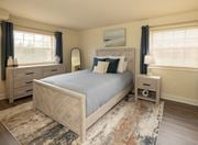 Windsor Mill apartment for rent - A bedroom with a large bed, nightstands, and a rug at Security Park Apartments*, Maryland, 21244