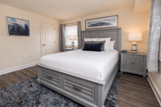 Lutherville-Timonium apartment for rent - A bedroom with a large bed and a painting on the wall.