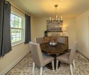 Pikesville apartment for rent - A dining room with a round table and chairs at The Brittany Apartments, Maryland