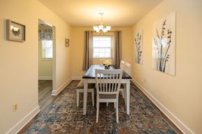 Baltimore townhouse for rent - Dining room with a table and chairs at Rockdale Gardens Apartments in Windsor Mill, MD.