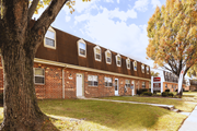 Baltimore apartment for rent - A brown building with a white door and windows at Kingston Townhomes, Baltimore, MD