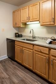 Towson apartment for rent - A kitchen with wooden cabinets and a granite countertop  at Ivy Hall Apartments*, Maryland, 21204
