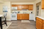 Windsor Mill apartment for rent - A kitchen with wooden cabinets and a white oven. at Security Park Apartments*, Maryland, 21244