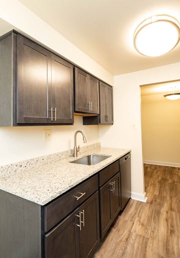 Lutherville-Timonium apartment for rent - a kitchen with dark wood cabinets and a granite counter top