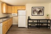 Essex apartment for rent - A kitchen with a white refrigerator and wooden cabinets at Hyde Park Apartments*, Essex, MD 21221