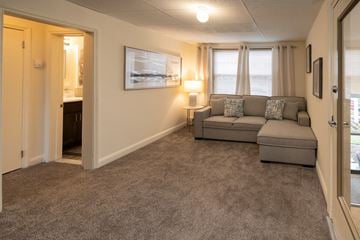 Baltimore apartment for rent - a living room with a couch and a door to a bathroom