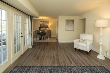 Pikesville apartment for rent - A living room with a chair and a lamp.
