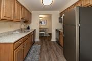 Towson apartment for rent - Kitchen with laminate vinyl plank floors and stainless steal appliances