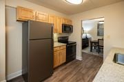 Towson apartment for rent - A kitchen with wooden cabinets and a granite countertop  at Ivy Hall Apartments*, Maryland, 21204