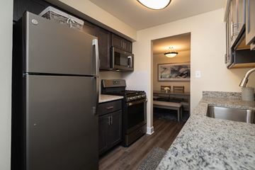 Lutherville-Timonium apartment for rent - A kitchen with a refrigerator, oven, and microwave.