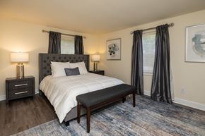 Baltimore apartment for rent - Bedroom with tufted headboard and upholstered bench at Spring Hill Apartments & Townhomes, Baltimore, 21234