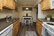 Baltimore apartment for rent - Eat-in kitchen with wooden cabinets and a dishwasher at Spring Hill Apartments & Townhomes, Baltimore, MD 21234.