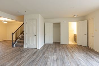 Living room in a house with a staircase in the background