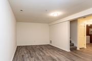 Baltimore apartment for rent - a living room with a hardwood floor and white walls at Carlson Woods Townhomes, Baltimore, Maryland