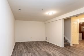 Baltimore apartment for rent - a living room with a hardwood floor and white walls at Carlson Woods Townhomes, Baltimore, Maryland