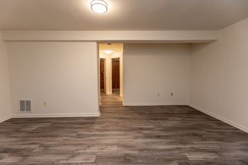 A bedroom with floor and white walls