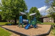 Randallstown apartment for rent - A playground with a blue slide and a green slide.at Deer Park Apartments, Randallstown, MD 21133