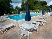 Randallstown apartment for rent - Community pool with lounge chairs at McDonogh Village Apartments & Townhomes, Randallstown, Maryland