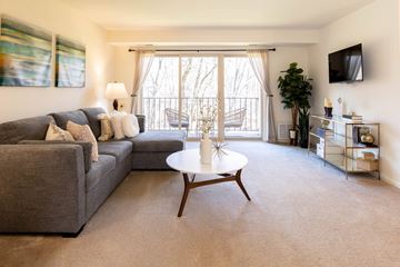 Baltimore apartment for rent - a living room with a gray couch and a white coffee table