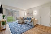 Abingdon apartment for rent - A living room with a couch, a rug, and a television at Woodsdale Apartments in Abingdon, MD