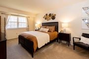 Baltimore apartment for rent - A bedroom with a large bed and a chair  at Village of Pine Run Apartments & Townhomes*, Maryland