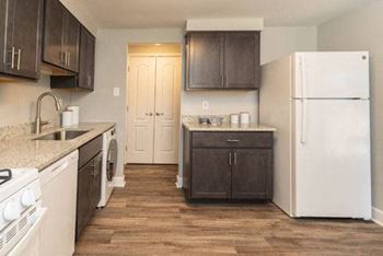 Kitchen with white appliances and brown cabinets