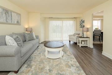 Baltimore apartment for rent - A living room with a grey couch and a round coffee table.