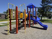 Baltimore apartment for rent - A playground with a blue slide and yellow and red play structures at Colony Hill Apartments & Townhomes, Baltimore, MD
