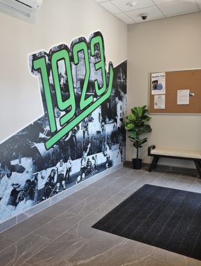Grand Forks apartment for rent - A wall with a 1923 sign and a photo of people playing baseball.