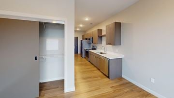 Grand Forks apartment for rent - A kitchen with wooden floors and white walls.