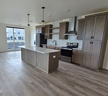Grand Forks apartment for rent - a kitchen with wooden cabinets and a large island in the middle