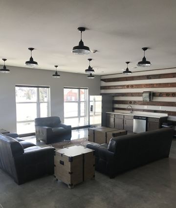 Grand Forks apartment for rent - A living room with a black couch and a wooden cabinet.