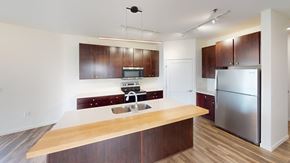 Grand Forks apartment for rent - A kitchen with a wooden counter top and stainless steel appliances.