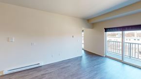 Grand Forks apartment for rent - A spacious room with a sliding glass door leading to a balcony.
