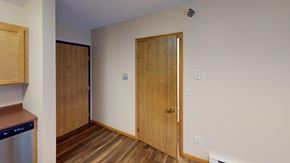 Grand Forks apartment for rent - A room with a wooden floor and a brown door.
