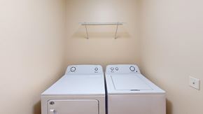 Grand Forks apartment for rent - Two white washing machines in a small laundry room.