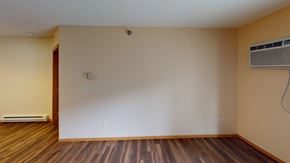 Grand Forks apartment for rent - A room with wooden floors and an air conditioner on the wall.