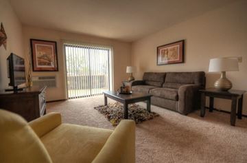 Waukesha apartment for rent - A living room with a yellow couch and a brown couch.