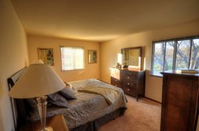 Waukesha apartment for rent - a bedroom with a bed and dresser and a window