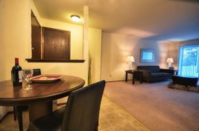 Middleton apartment for rent - a living room and dining room with a table and a bottle of wine