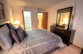 Middleton apartment for rent - a bedroom with a large bed and a dresser and a bathroom