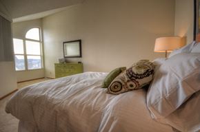 New Berlin apartment for rent - the master bedroom has a large bed and a view
