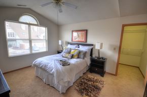 New Berlin apartment for rent - a bedroom with a bed and a ceiling fan