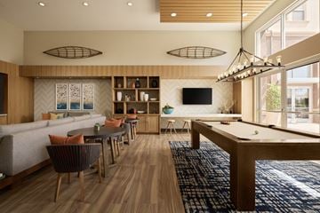 Laguna Hills apartment for rent - A modern living room with a pool table and a bar area.