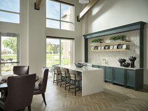 Englewood apartment for rent - A kitchen with large windows, island seating, and modern fixtures at The Sophia in Englewood.