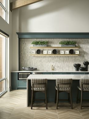 Englewood apartment for rent - A kitchen with white counter tops, striped chairs, and modern fixtures  at The Sophia in Englewood.