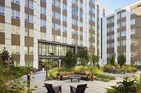 Shoreline apartment for rent - Enclosed courtyard seating with hammocks and a clubhouse at Verdant Apartments in Shoreline.
